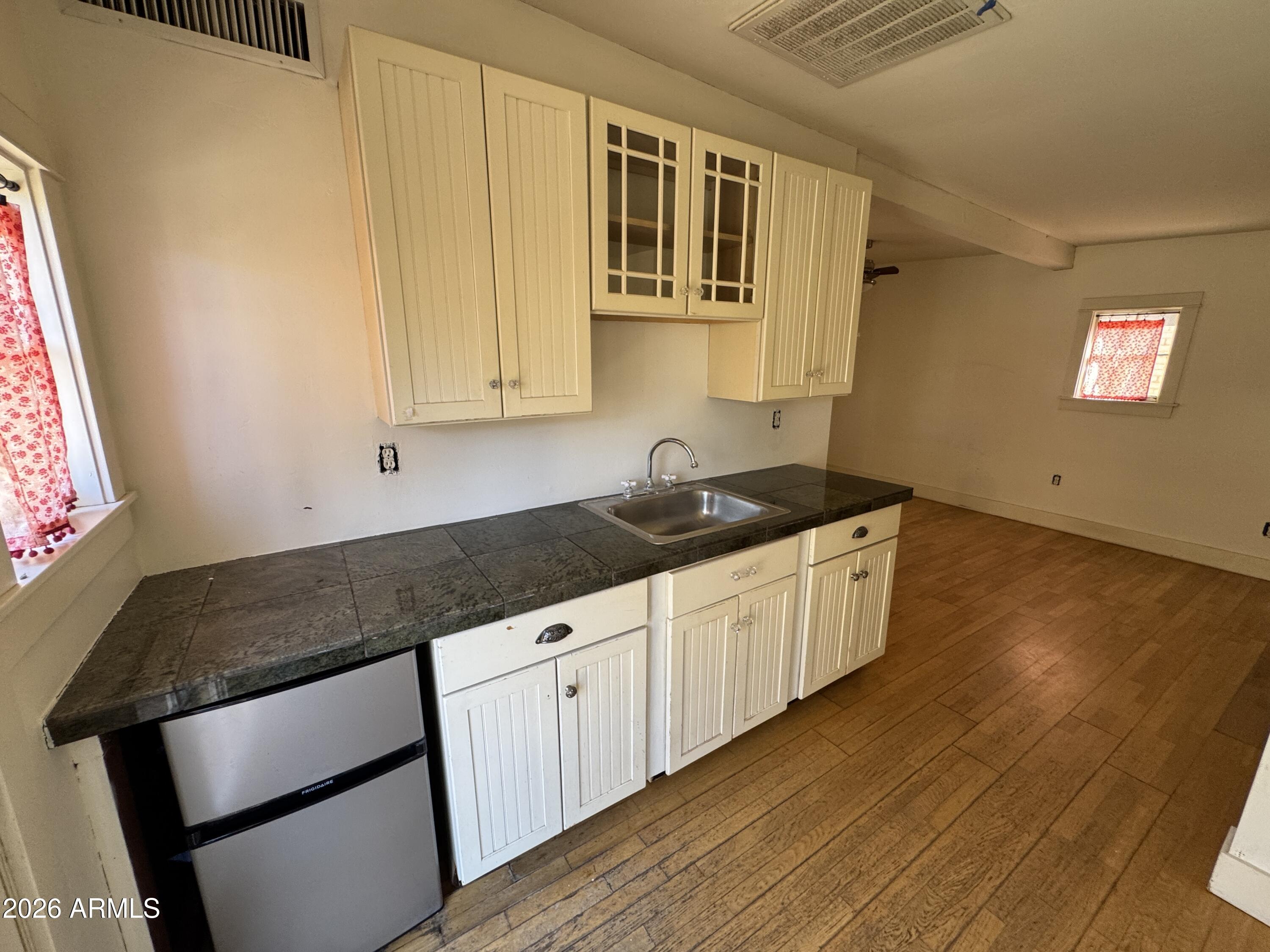 505 West Granada Road Phoenix, AZ 85003 - Photo 27 of 30 a kitchen with granite countertop a sink a stove and cabinets