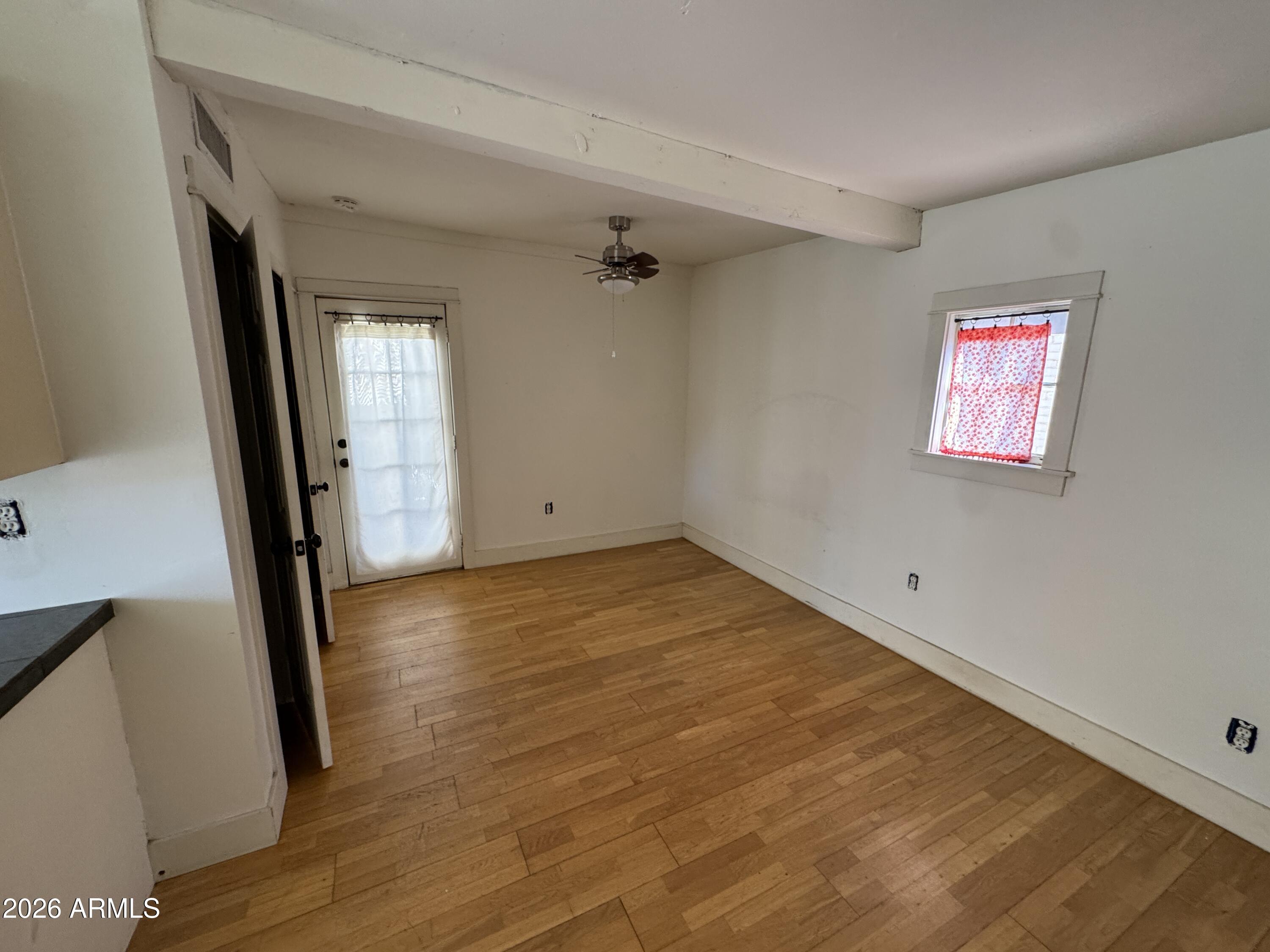 505 West Granada Road Phoenix, AZ 85003 - Photo 28 of 30 an empty room with wooden floor and a window