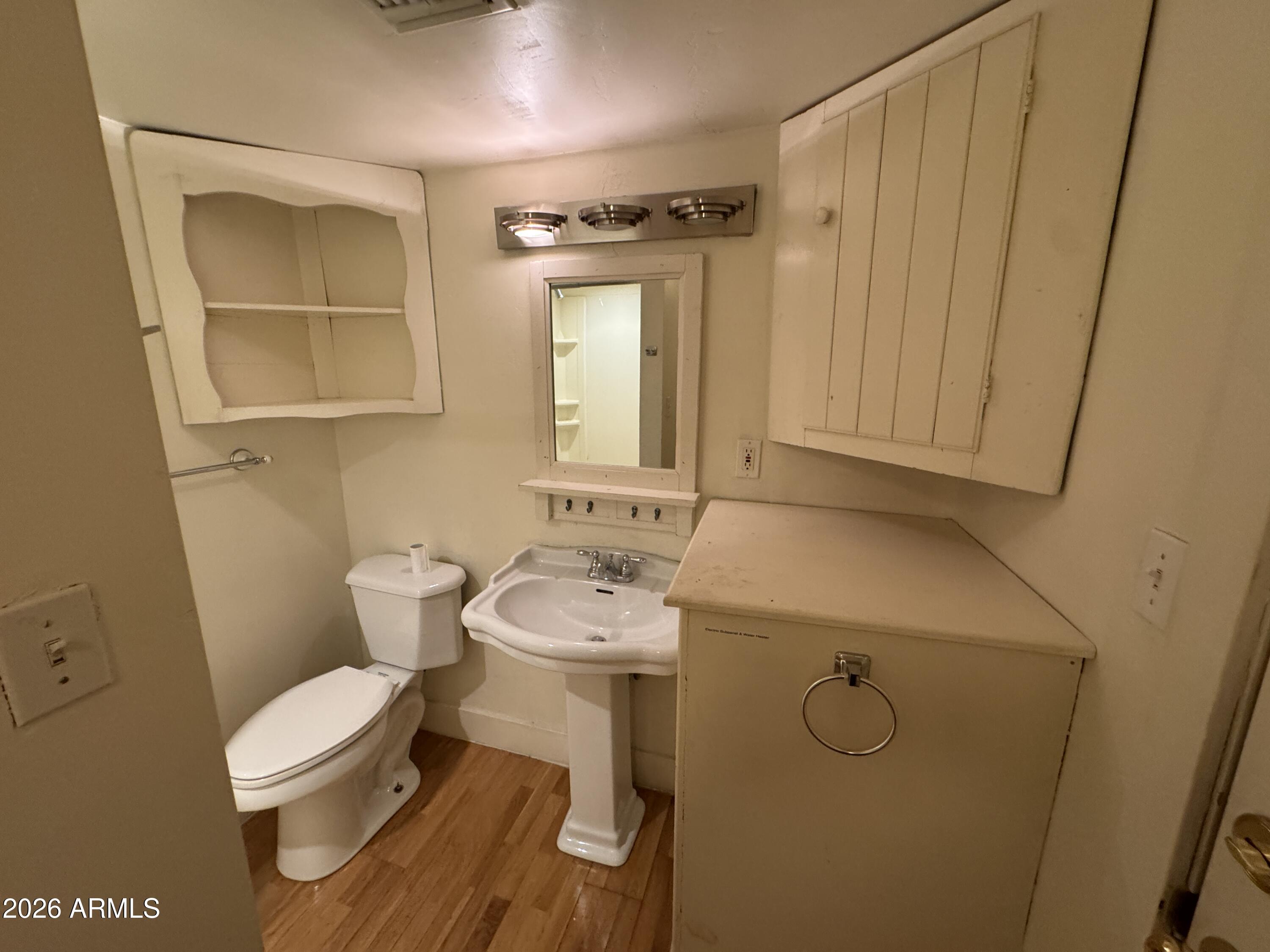 505 West Granada Road Phoenix, AZ 85003 - Photo 29 of 30 a bathroom with a toilet sink and mirror