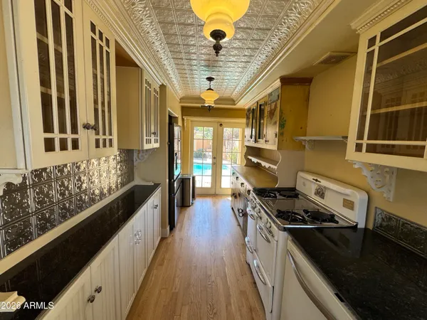 a kitchen with stainless steel appliances a stove a sink and a refrigerator