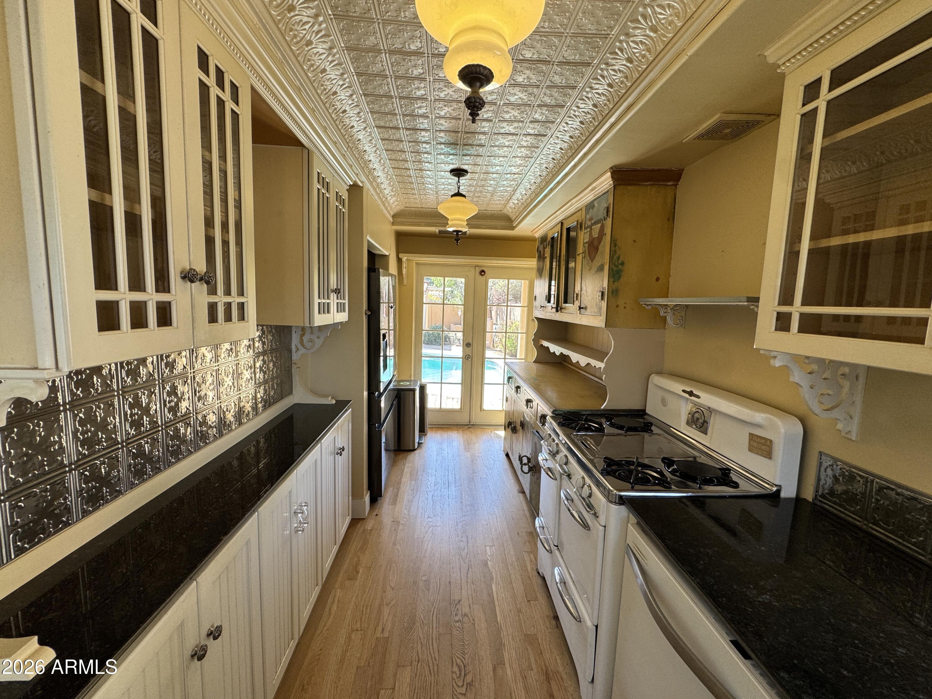 505 West Granada Road Phoenix, AZ 85003 - Photo 6 of 30 a kitchen with stainless steel appliances a stove a sink and a refrigerator