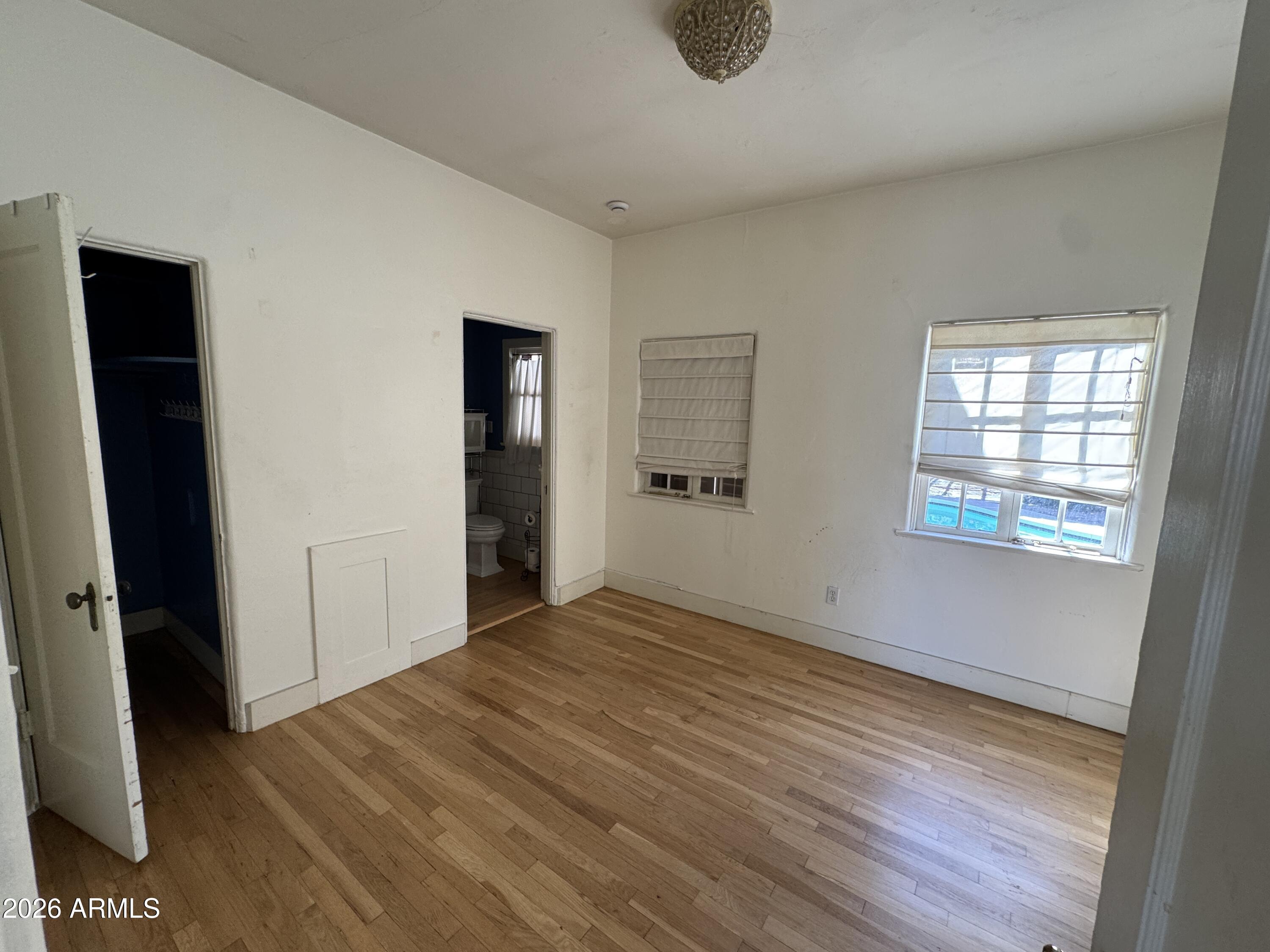 505 West Granada Road Phoenix, AZ 85003 - Photo 9 of 30 a view of an empty room with wooden floor and a window