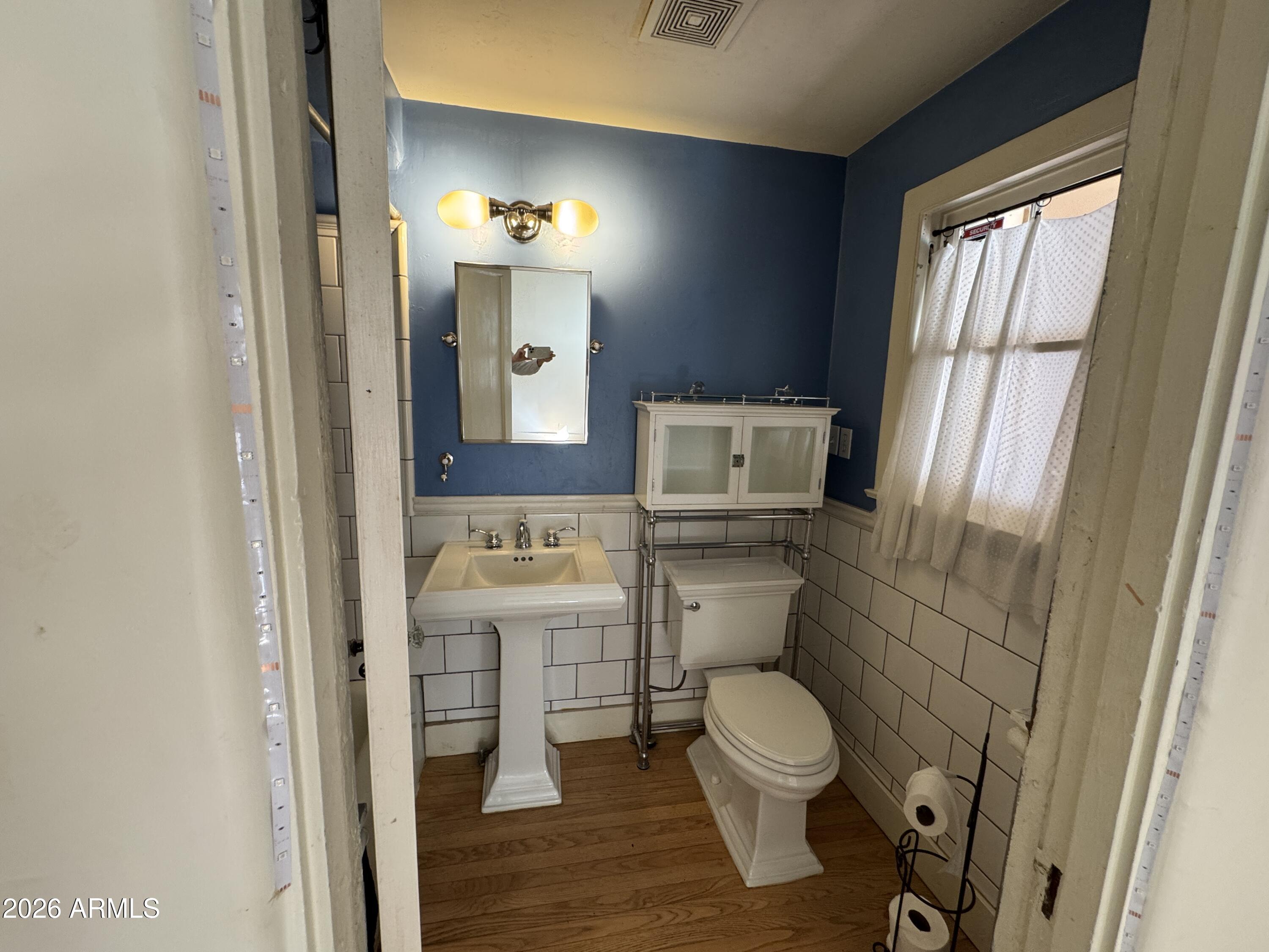 505 West Granada Road Phoenix, AZ 85003 - Photo 10 of 30 a bathroom with a toilet a sink and a mirror