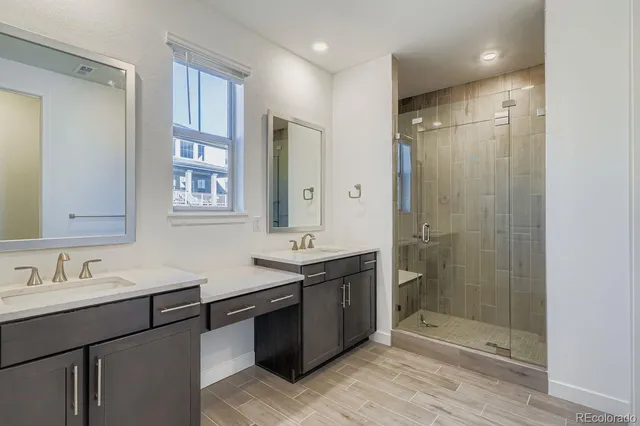 a bathroom with a shower sink and mirror