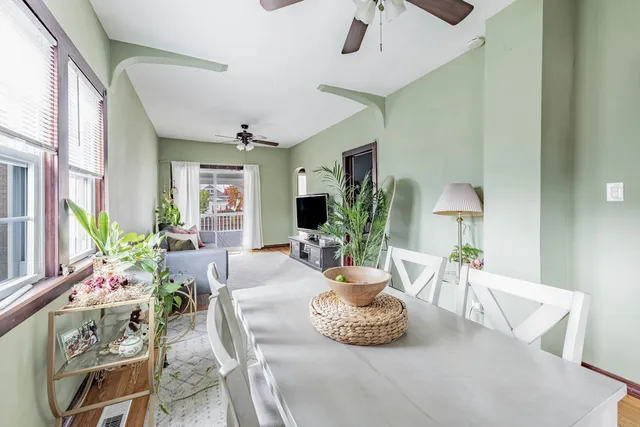 a living room with furniture and a potted plant