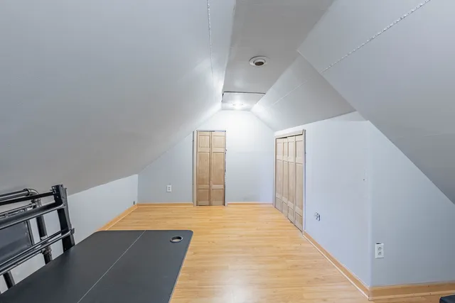 a view of a livingroom with wooden floor and a staircase