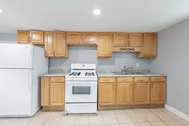a kitchen with a stove top oven sink and cabinets