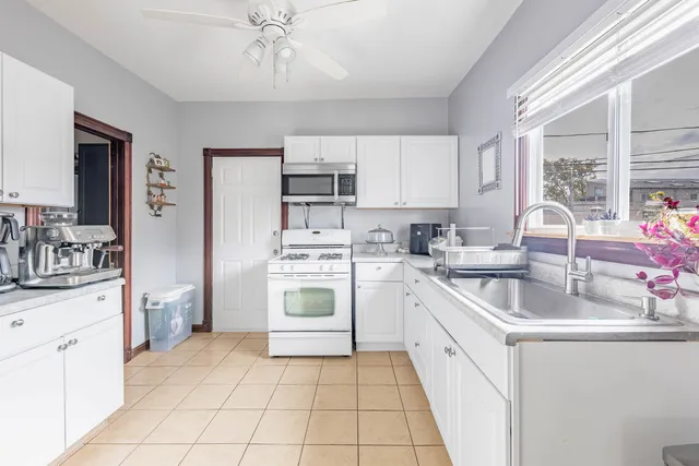 a kitchen with a sink stove and cabinets