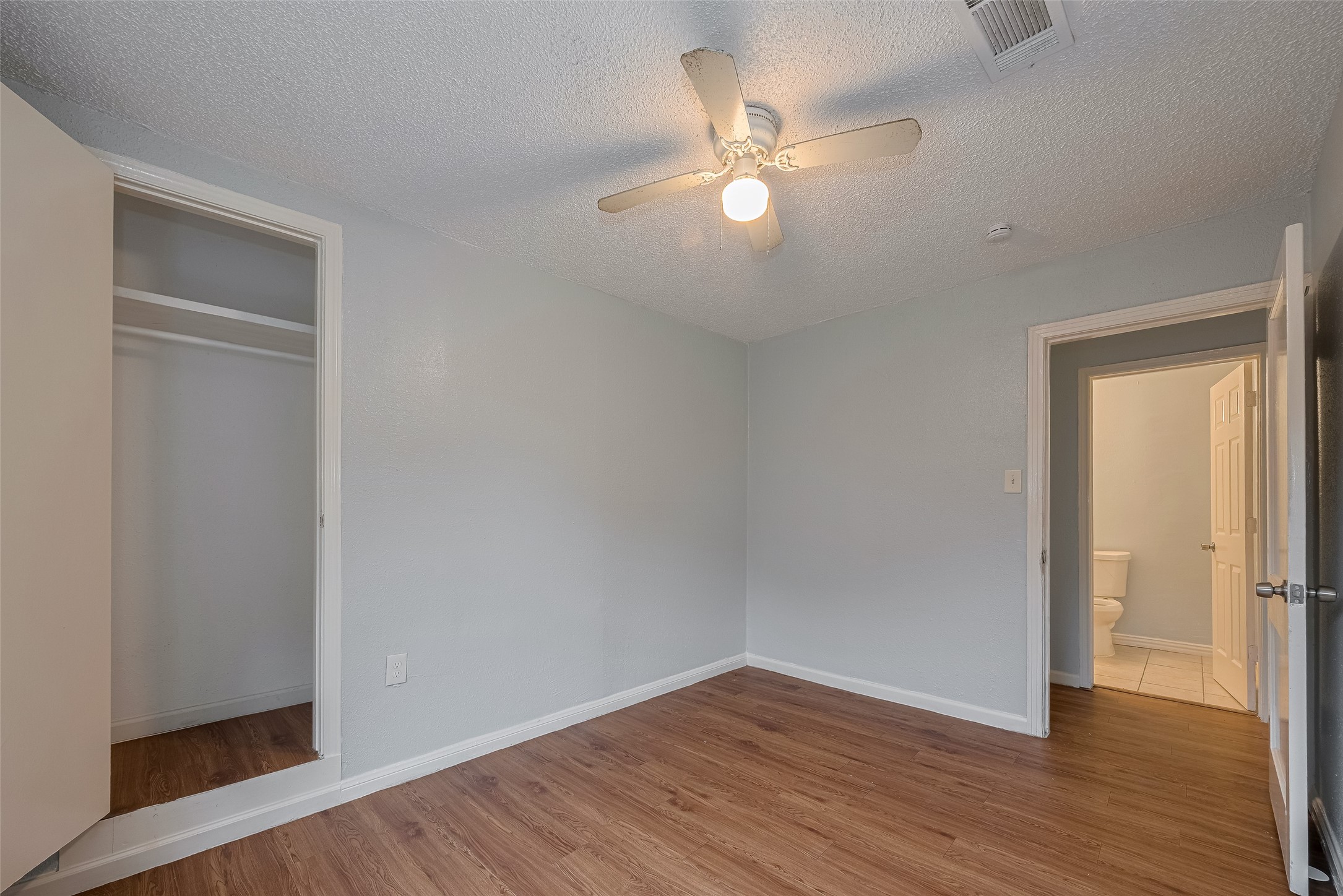 4906 Larkspur Street Houston, TX 77033 - Photo 9 of 14 wooden floor in an empty room with a window