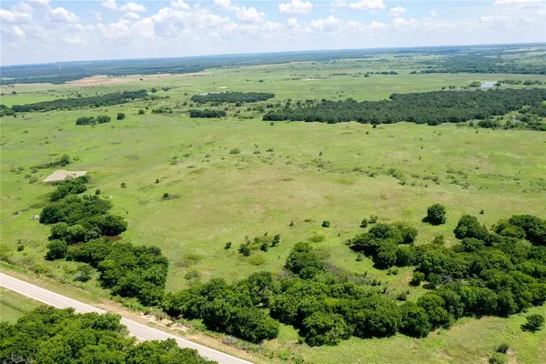 a view of a field with an ocean