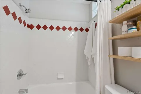an empty room with wooden floor and sliding door