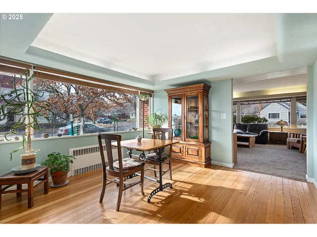a dining room with furniture and wooden floor