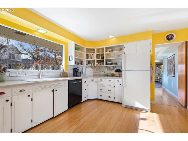 a living room with furniture and a dining table with wooden floor