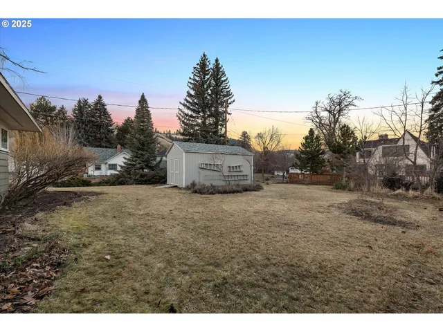 a view of a house with a tree in the background