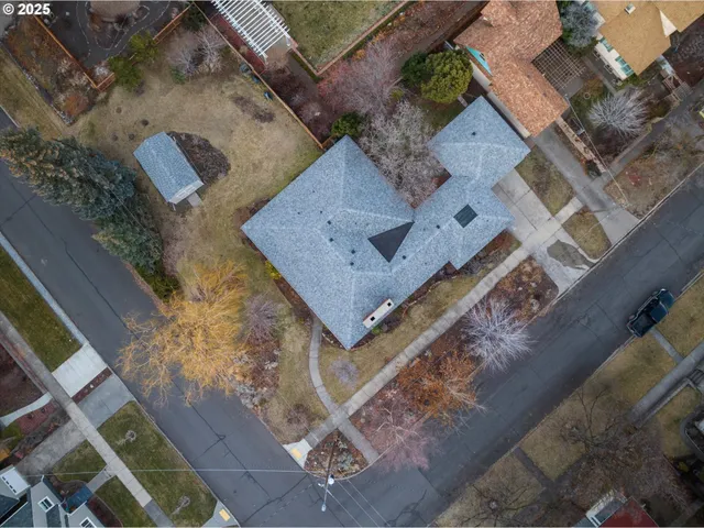 an aerial view of a house with a yard