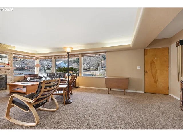 a view of a dining room with furniture and a floor to ceiling window
