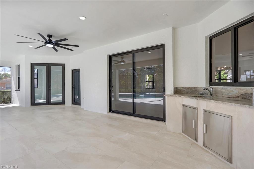 730 29th Street Southwest Naples, FL 34117 - Photo 36 of 50 View of patio featuring an outdoor kitchen, a ceiling fan, and french doors