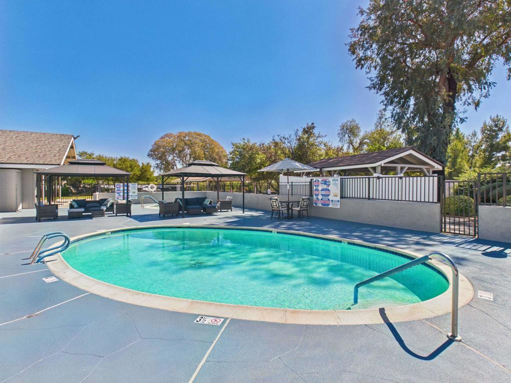 18218 Paradise Mountain Road, Unit 220 Valley Center, CA 92082 - Photo 10 of 48 a view of a house with a swimming pool