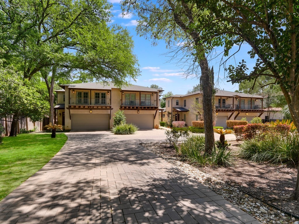 a front view of a house with garden and patio