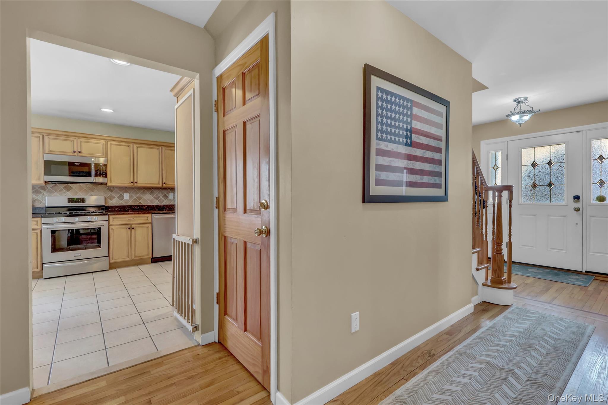 18 Hampton Road Lynbrook, NY 11563 - Photo 11 of 37 a view of a kitchen with a refrigerator a stove top oven cabinets