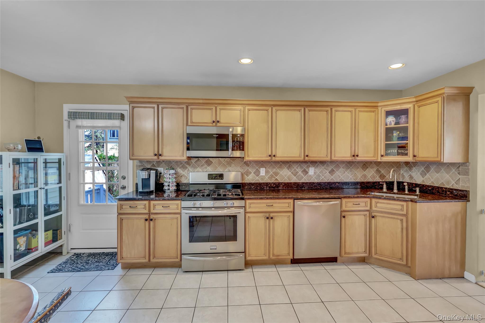 18 Hampton Road Lynbrook, NY 11563 - Photo 16 of 37 a kitchen with a stove sink and cabinets