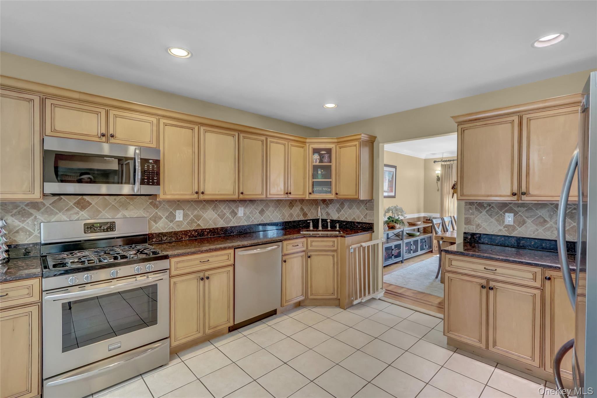 18 Hampton Road Lynbrook, NY 11563 - Photo 17 of 37 a kitchen with granite countertop white cabinets white stainless steel appliances with a sink and dishwasher