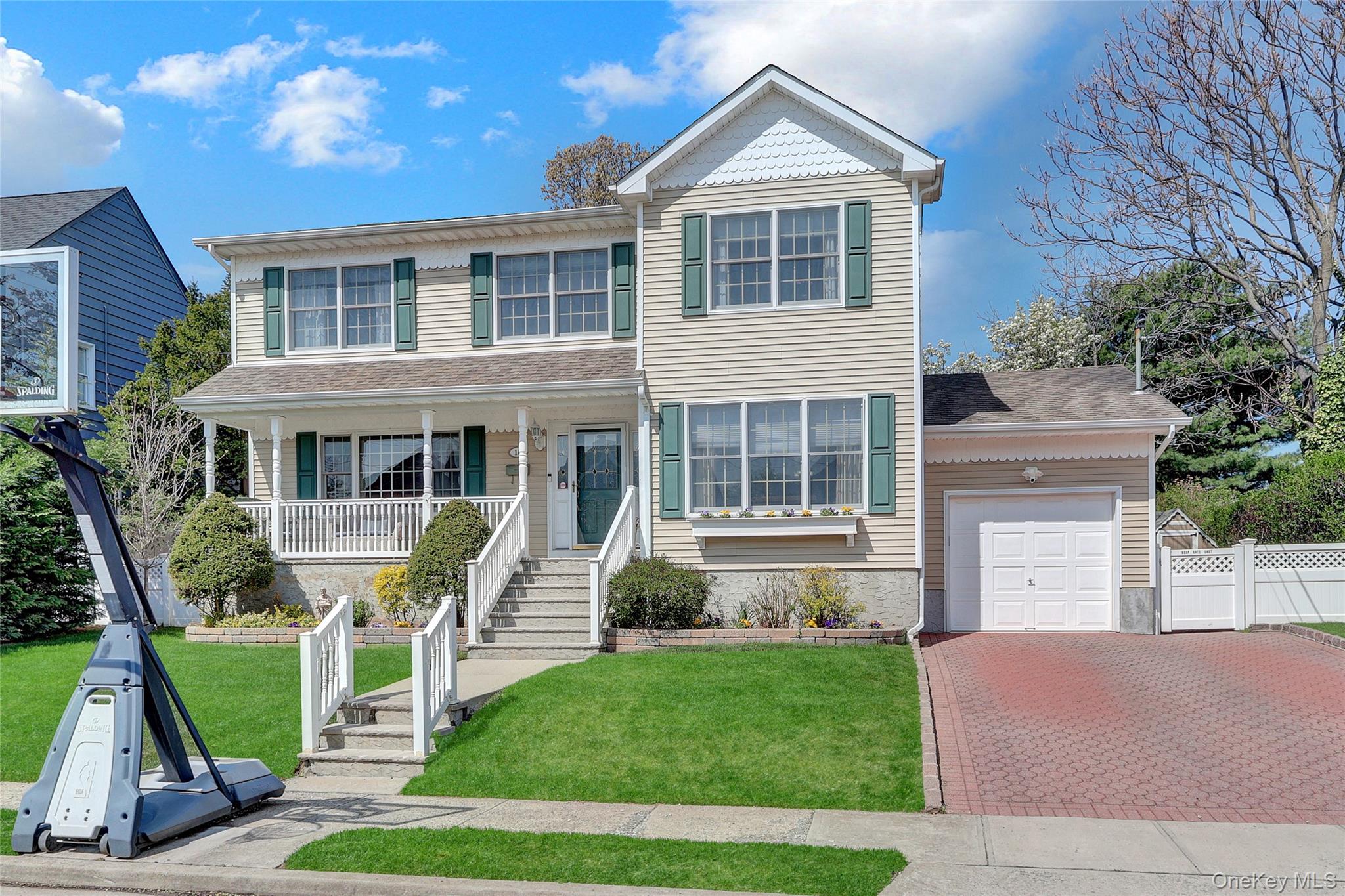 18 Hampton Road Lynbrook, NY 11563 - Photo 2 of 37 a front view of a house with a yard