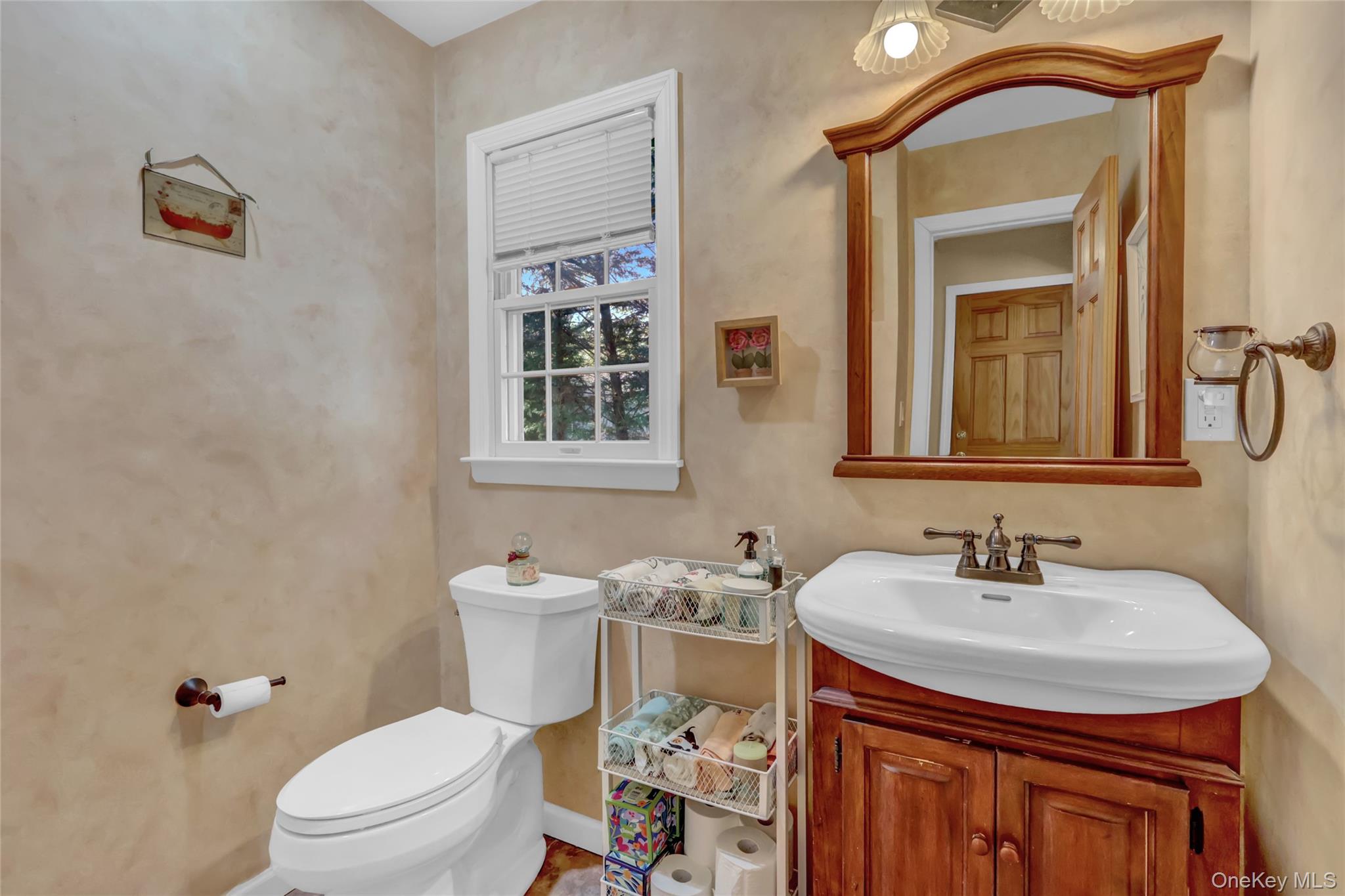 18 Hampton Road Lynbrook, NY 11563 - Photo 21 of 37 a bathroom with a sink a toilet and mirror