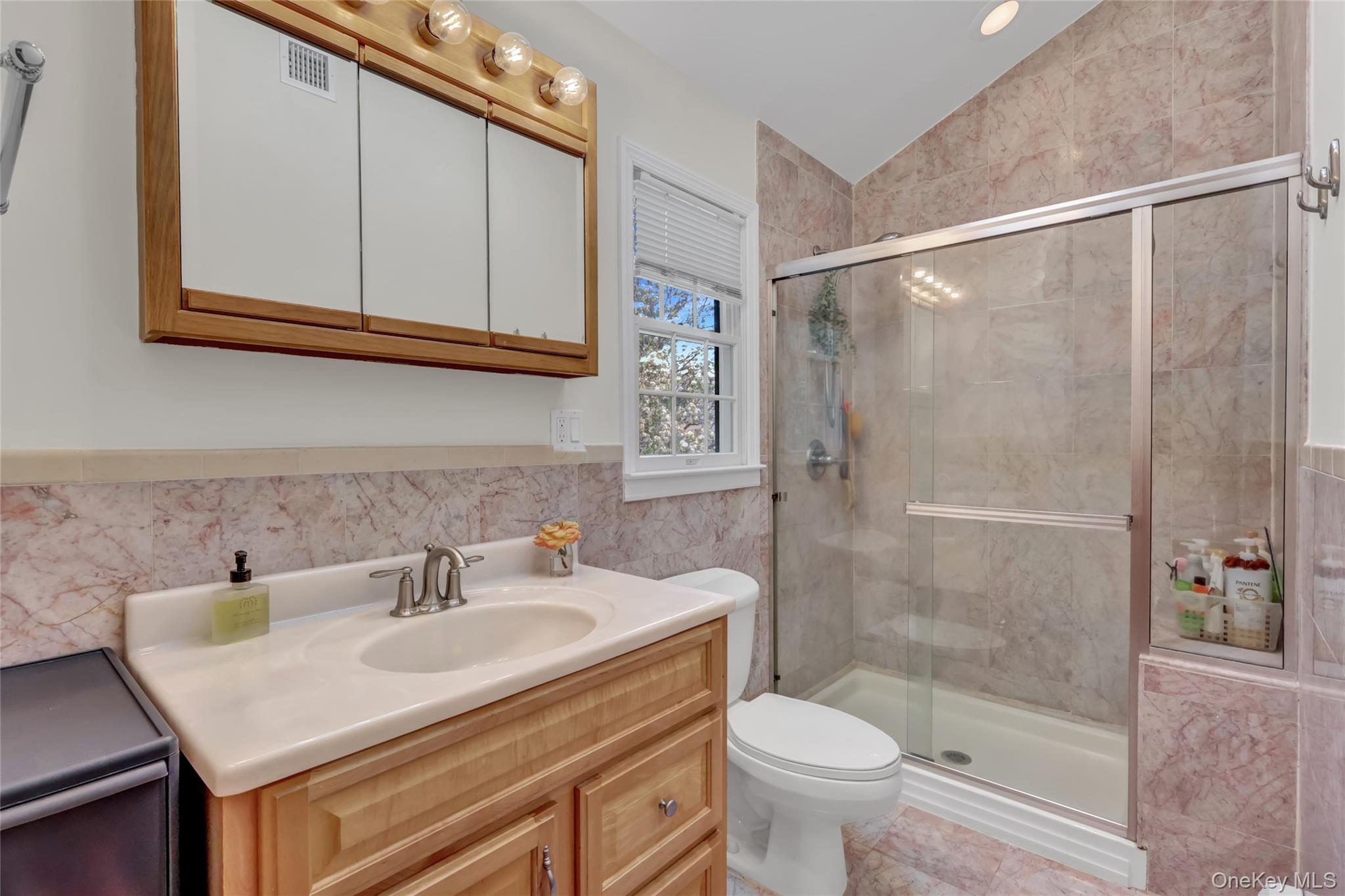 18 Hampton Road Lynbrook, NY 11563 - Photo 28 of 37 a bathroom with a sink toilet and shower