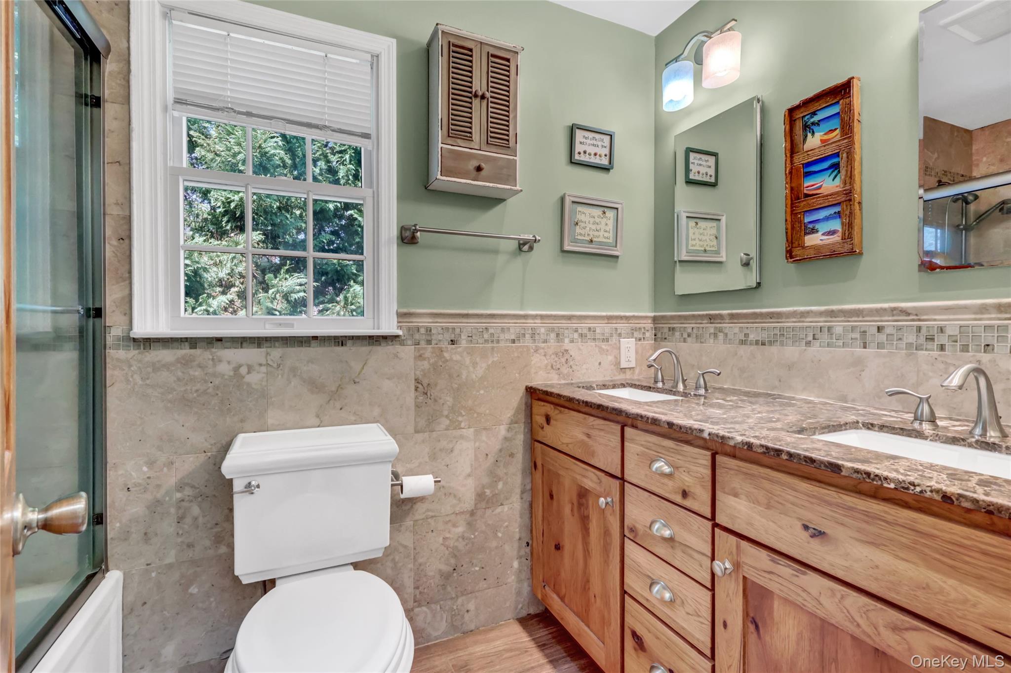 18 Hampton Road Lynbrook, NY 11563 - Photo 29 of 37 a bathroom with a toilet sink and mirror