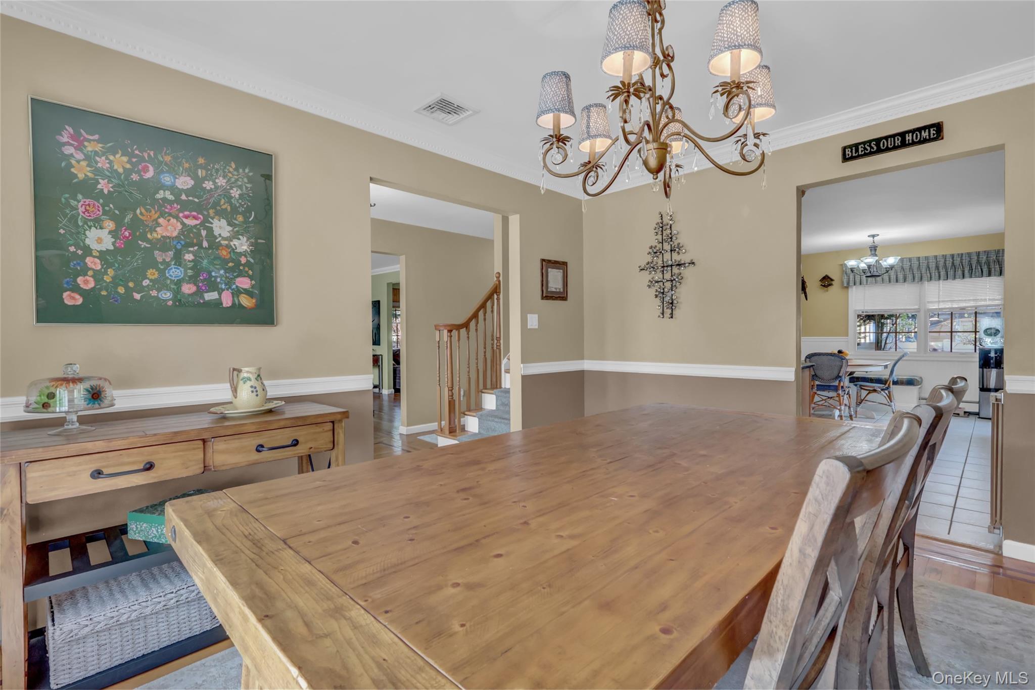18 Hampton Road Lynbrook, NY 11563 - Photo 7 of 37 a view of a dining room and livingroom with furniture wooden floor a rug a chandelier