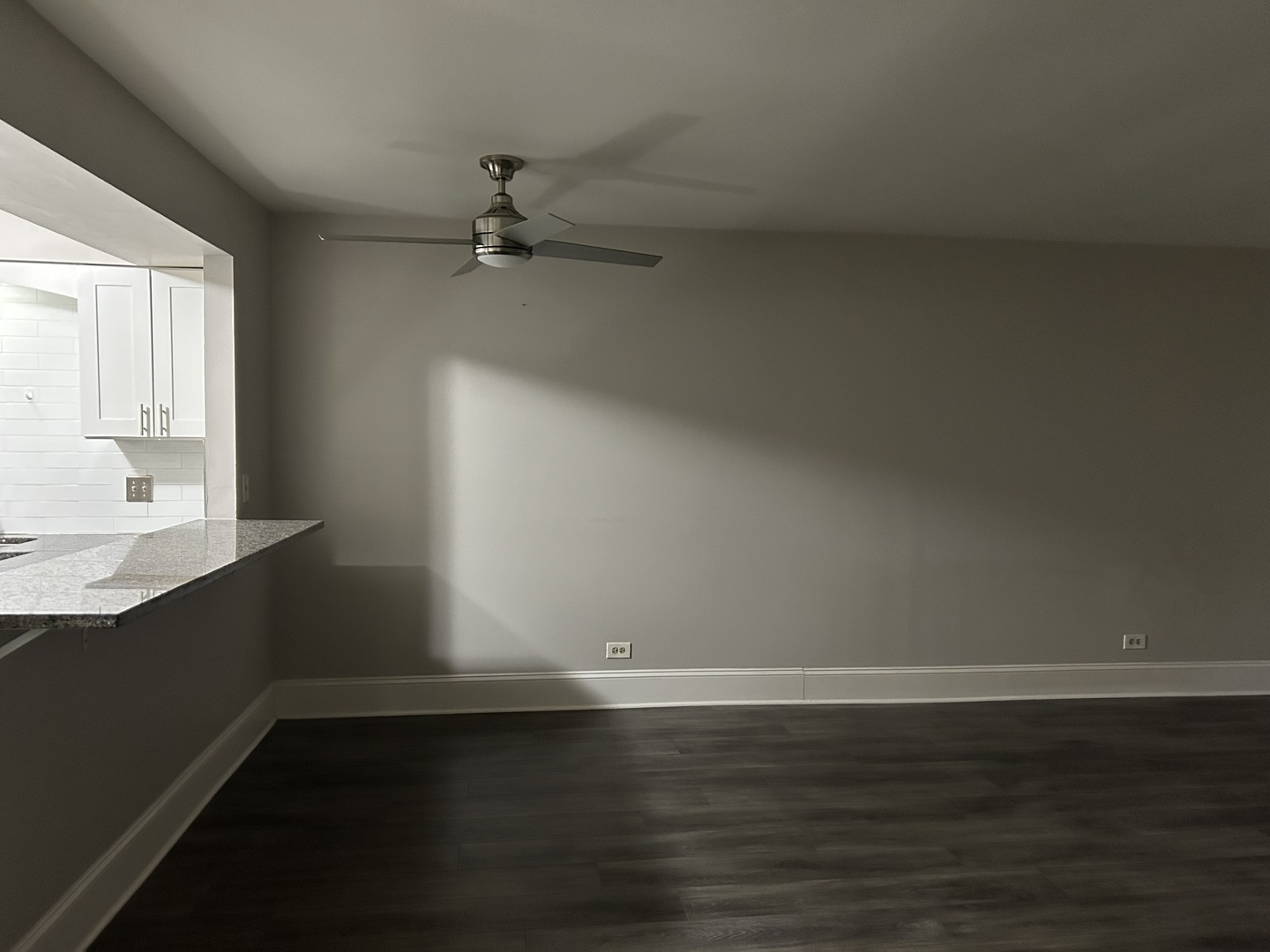 235 North Mill Road, Unit 114B Addison, IL 60101 - Photo 13 of 28 a view of an empty room with wooden floor and a window