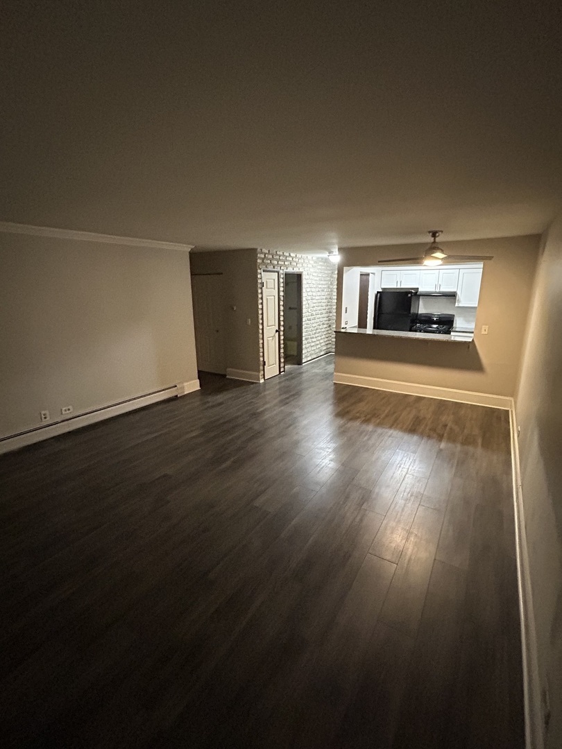 235 North Mill Road, Unit 114B Addison, IL 60101 - Photo 14 of 28 a view of empty room with wooden floor
