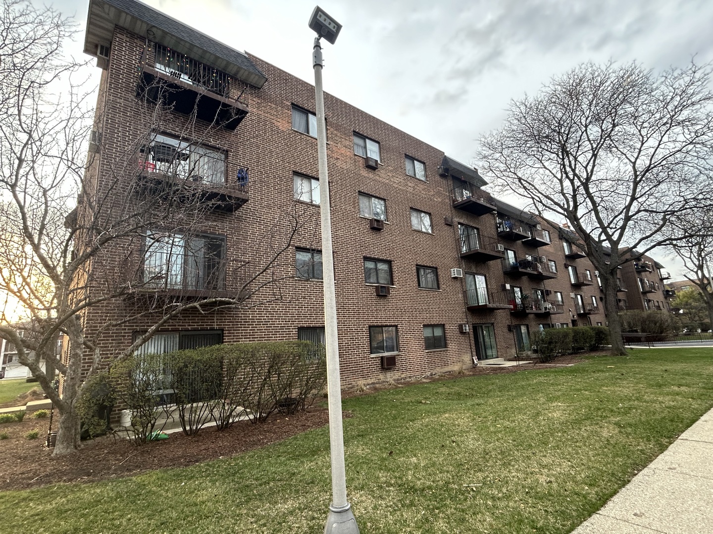 235 North Mill Road, Unit 114B Addison, IL 60101 - Photo 25 of 28 a view of a building with a yard