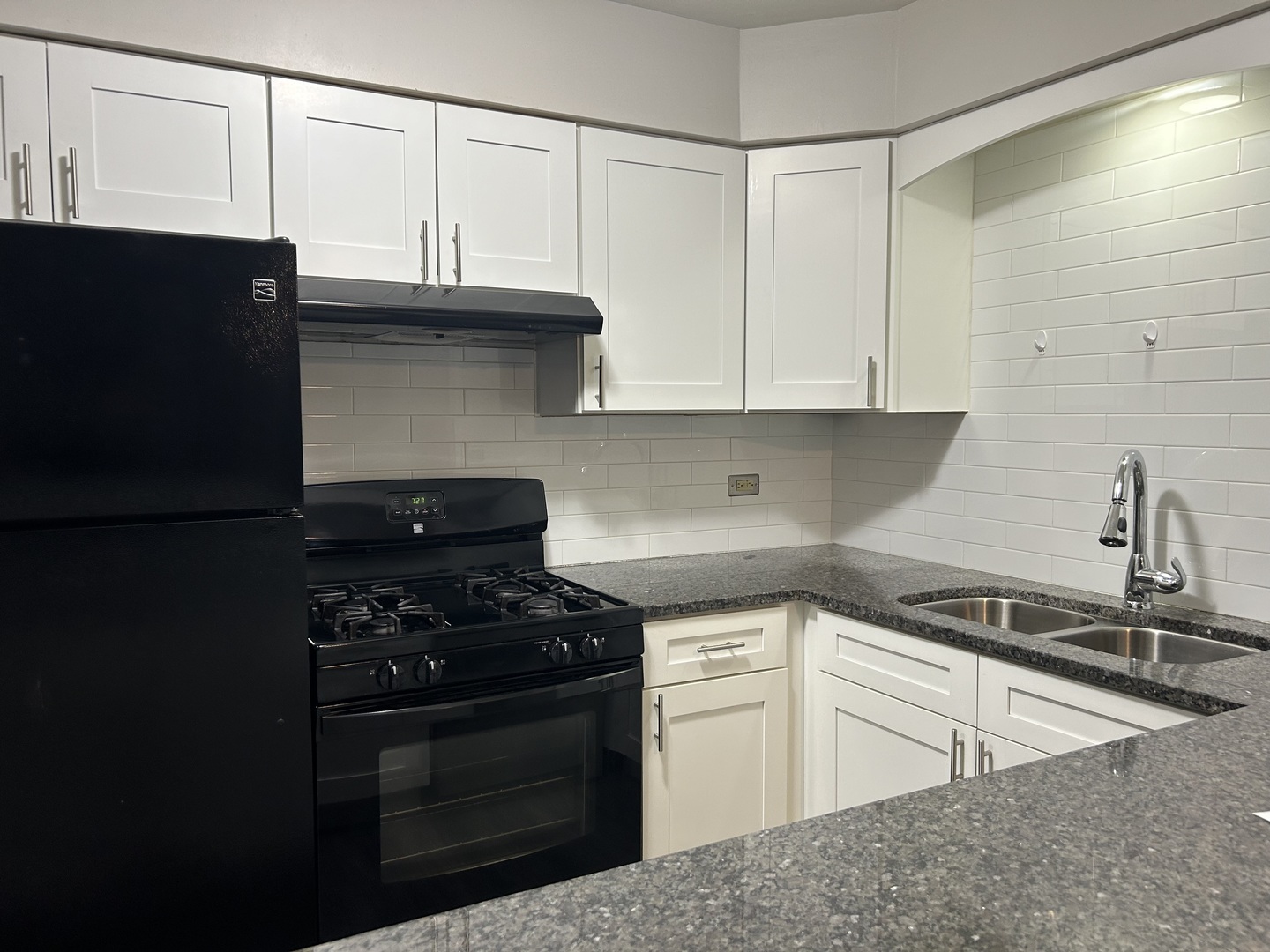235 North Mill Road, Unit 114B Addison, IL 60101 - Photo 4 of 28 a kitchen with granite countertop a sink a stove and cabinets