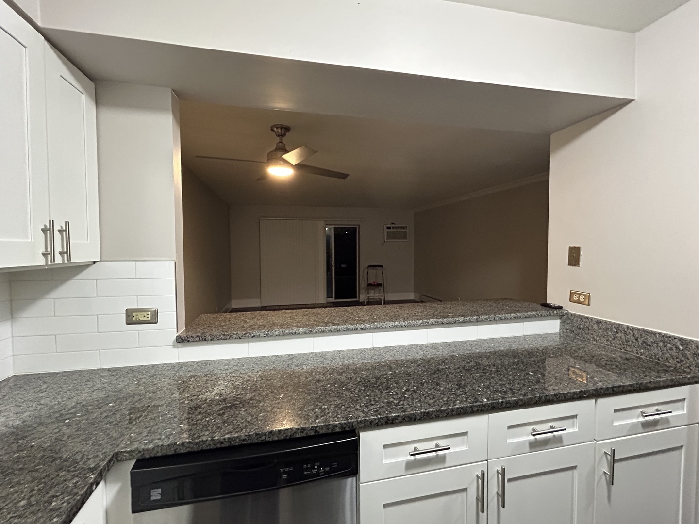235 North Mill Road, Unit 114B Addison, IL 60101 - Photo 5 of 28 a kitchen with granite countertop a sink and cabinets