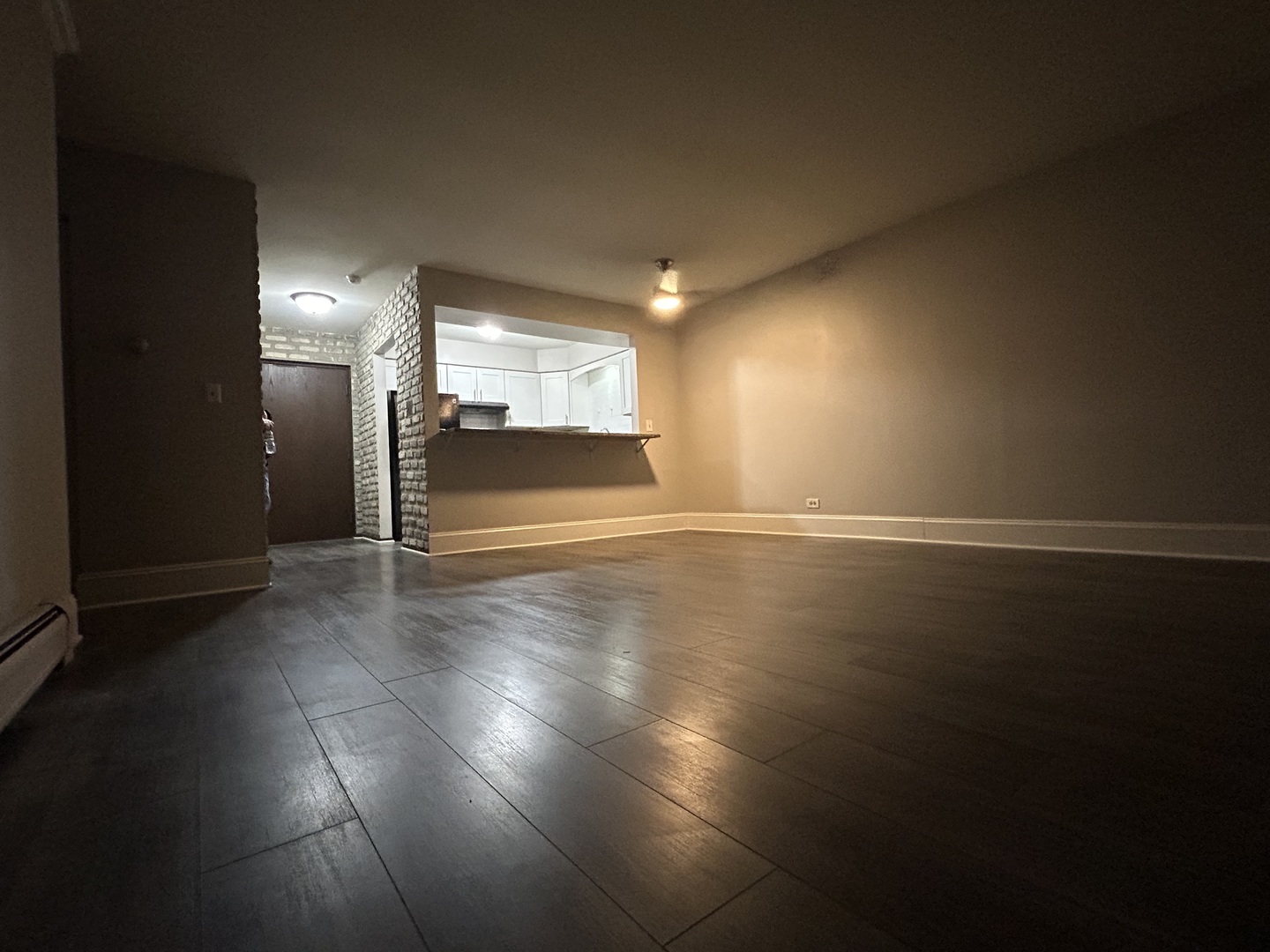 235 North Mill Road, Unit 114B Addison, IL 60101 - Photo 7 of 28 an empty room with wooden floor and windows
