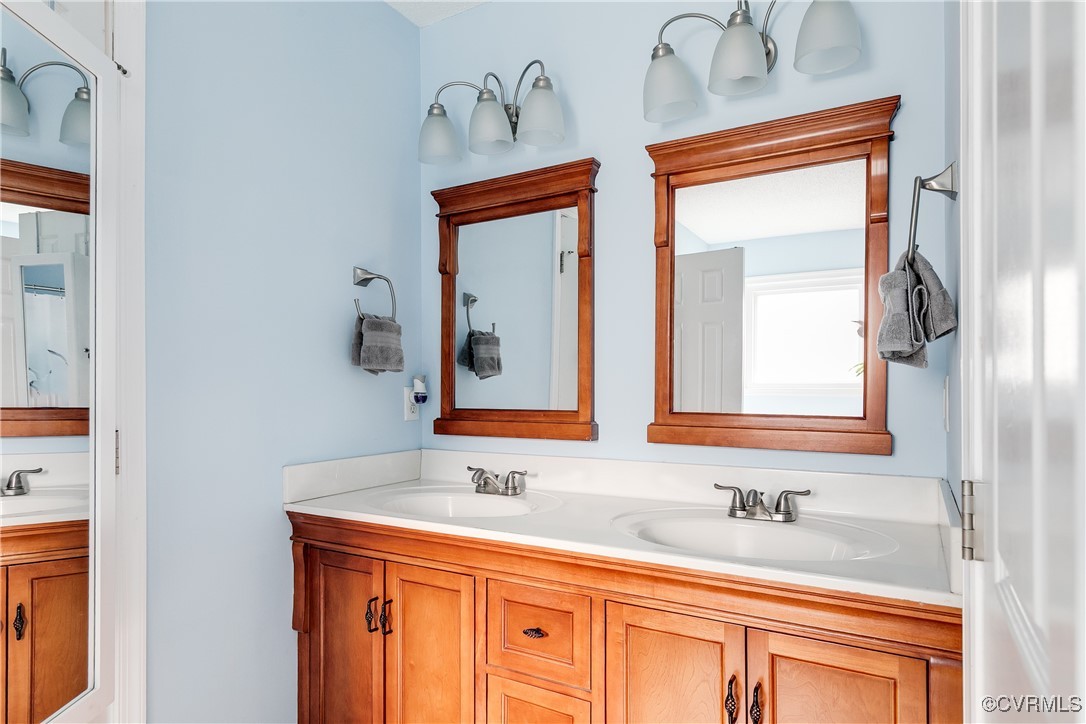 3003 Chartwood Drive Sandston, VA 23150 - Photo 17 of 29 a bathroom with a sink and a mirror