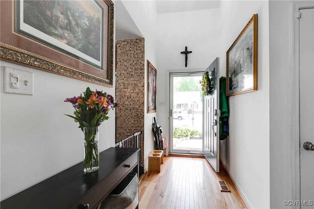 3003 Chartwood Drive Sandston, VA 23150 - Photo 2 of 29 a view of a hallway with wooden floor and a potted plant