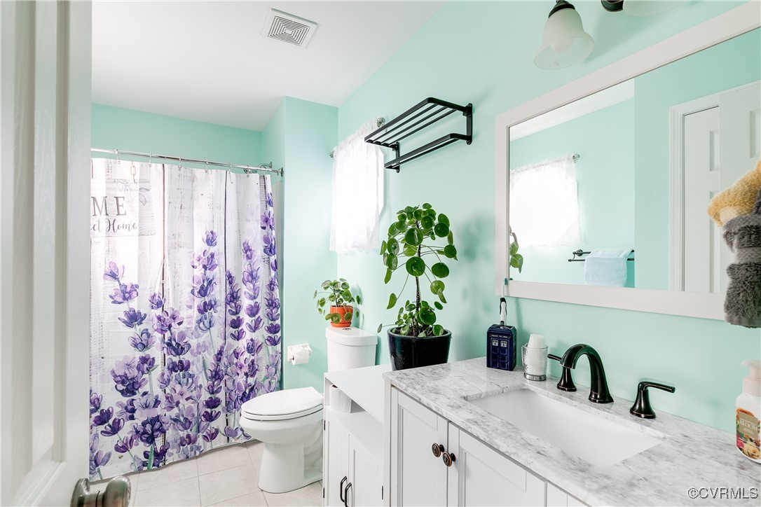 3003 Chartwood Drive Sandston, VA 23150 - Photo 21 of 29 a bathroom with a granite countertop sink a toilet and a mirror