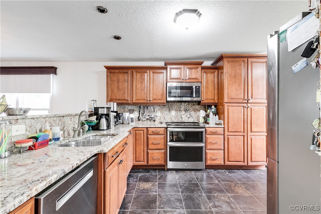 3003 Chartwood Drive Sandston, VA 23150 - Photo 3 of 29 a kitchen with stainless steel appliances granite countertop a sink stove microwave and refrigerator