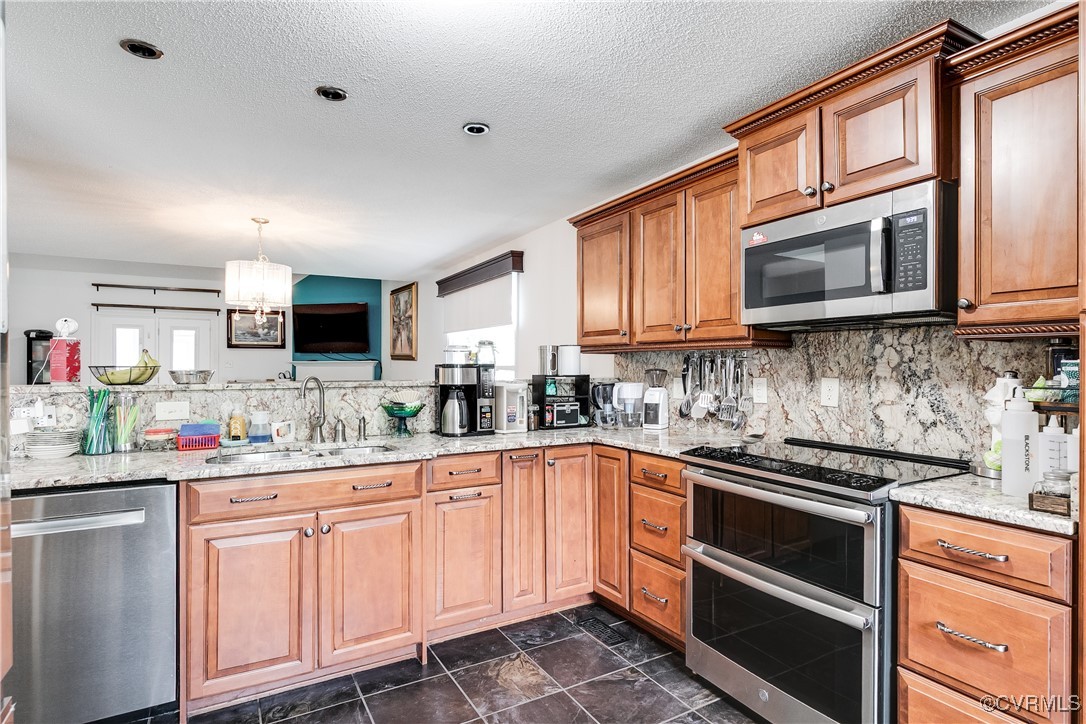 3003 Chartwood Drive Sandston, VA 23150 - Photo 7 of 29 a kitchen with stainless steel appliances granite countertop a sink stove and cabinets
