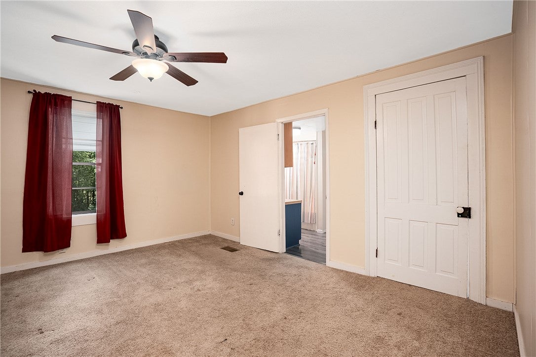 59 Church Street Notasulga, AL 36866 - Photo 15 of 38 This spacious bedroom offers ample comfort and natural light.