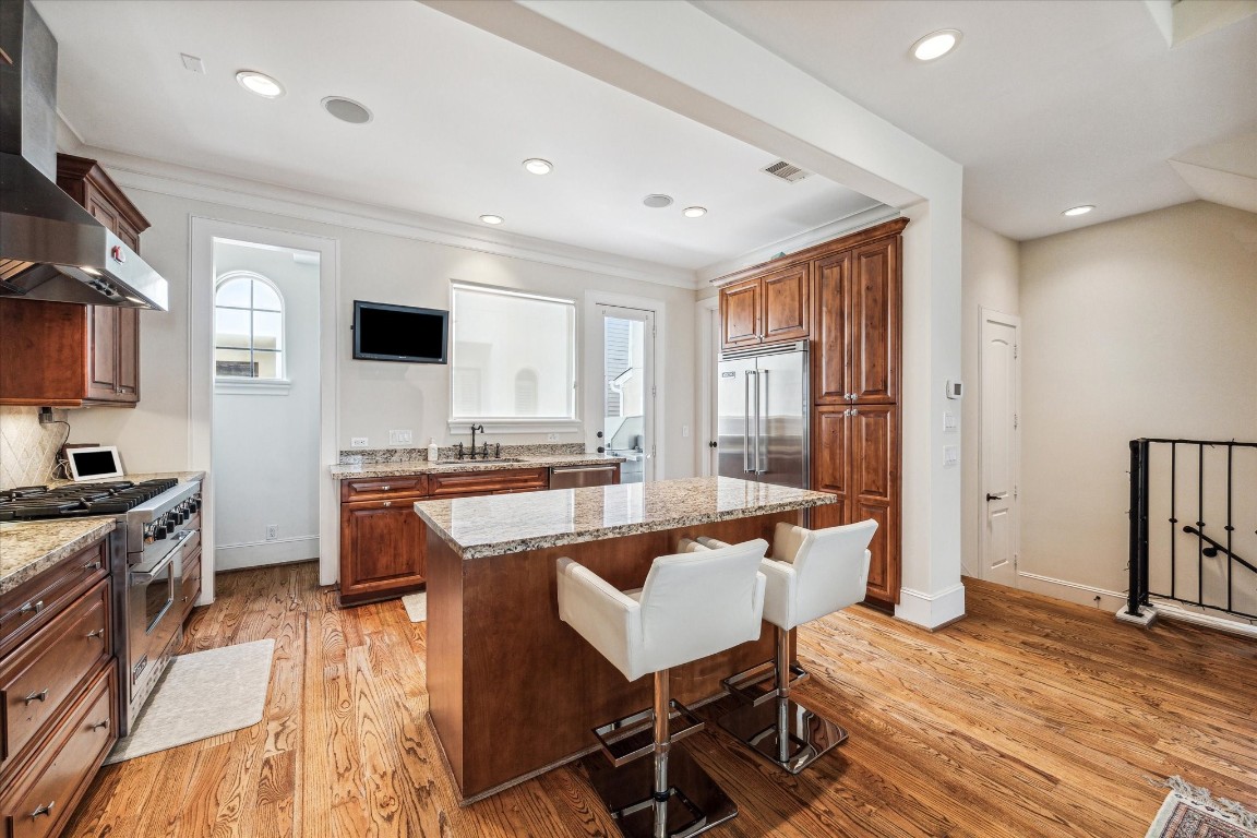 5213 Feagan Street, Unit A Houston, TX 77007 - Photo 13 of 47 a large room with kitchen island granite countertop lots of counter top space and stainless steel appliances
