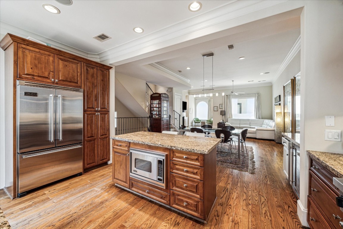 5213 Feagan Street, Unit A Houston, TX 77007 - Photo 20 of 47 a large kitchen with stainless steel appliances granite countertop a stove and a wooden floors