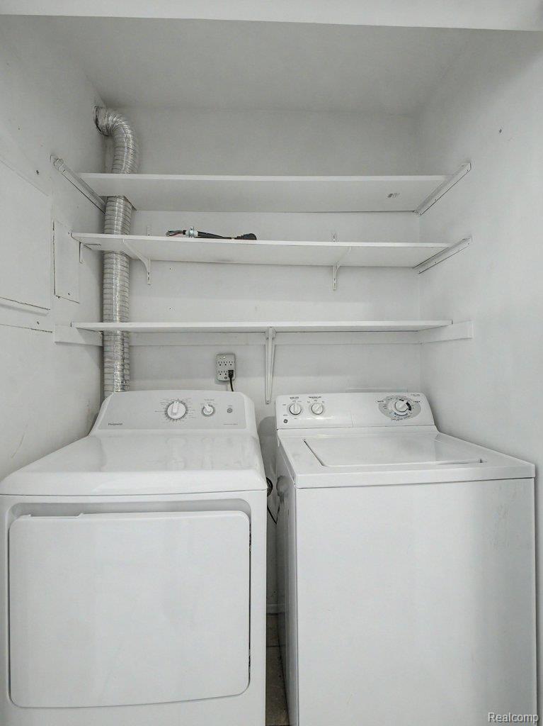 1974 Klingensmith Road, Unit 4 Bloomfield Hills, MI 48302 - Photo 11 of 35 Dedicated laundry area featuring a white top-load washing machine and a white front-load dryer