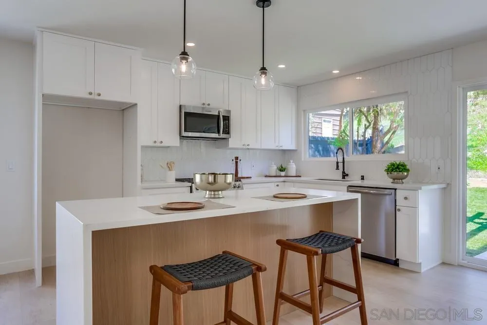 12701 McFeron Road Poway, CA 92064 - Photo 11 of 32 a kitchen with a sink a center island and cabinets