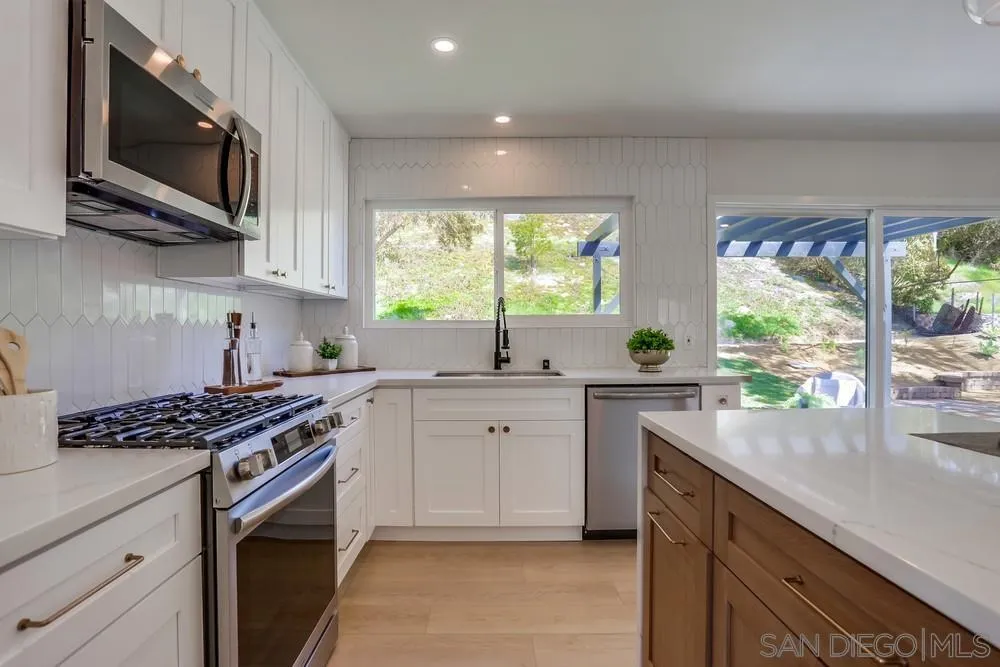 12701 McFeron Road Poway, CA 92064 - Photo 13 of 32 a kitchen with stainless steel appliances a sink stove and microwave