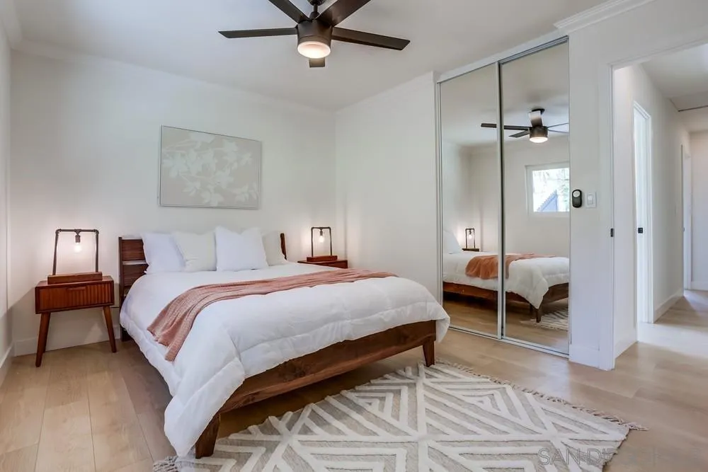 12701 McFeron Road Poway, CA 92064 - Photo 18 of 32 a bedroom with a bed and a chandelier