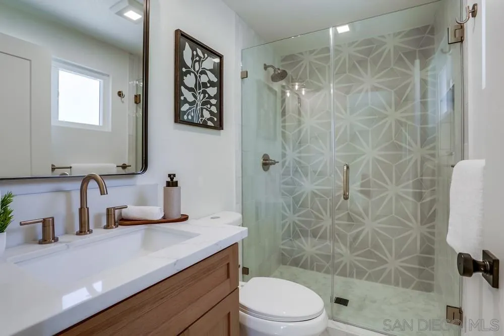12701 McFeron Road Poway, CA 92064 - Photo 20 of 32 a bathroom with a sink a toilet and shower